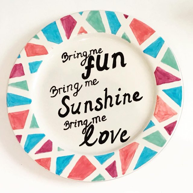 Plate with painted triangles and text.
