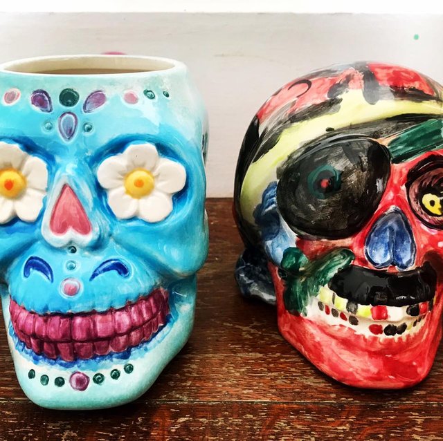 Two decorated ceramic skulls
