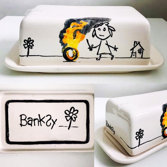 A white square with a drawing of a person, tree, and fire.