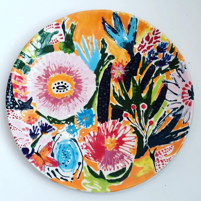 Vibrant illustration of pink, blue, and orange flowers with black details.