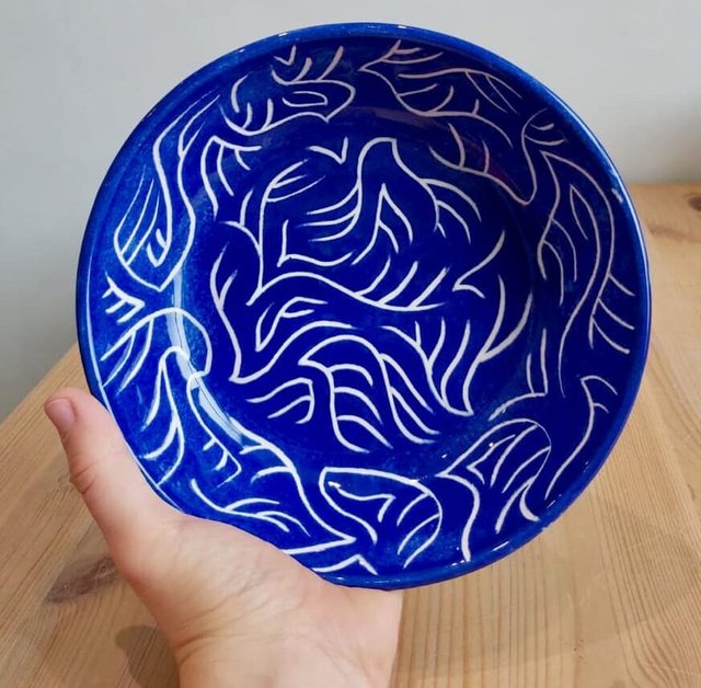 Blue pottery bowl with white swirl pattern.