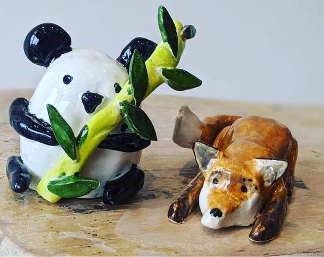 Ceramic panda and fox figurines.